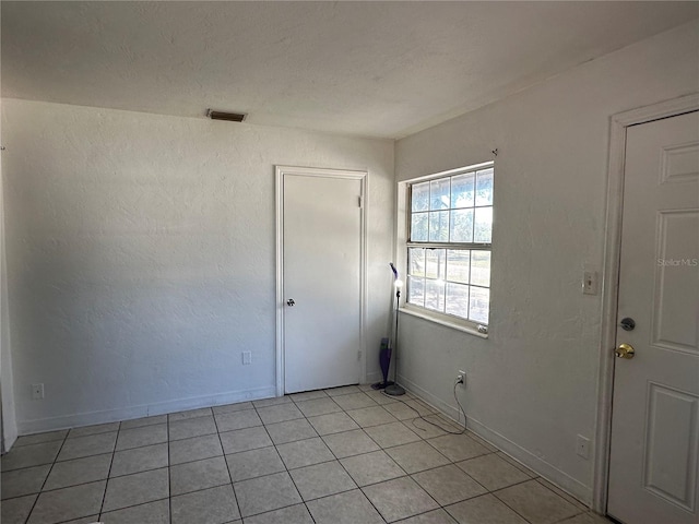 unfurnished room with light tile patterned floors