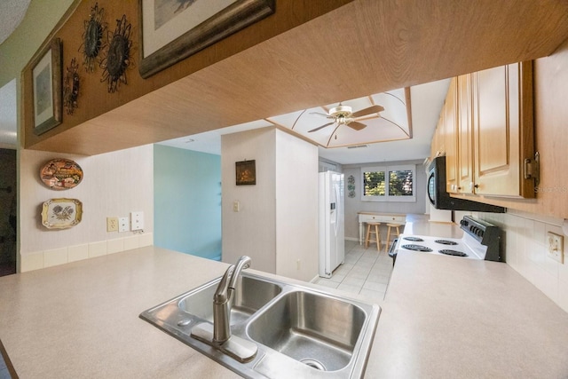 kitchen with ceiling fan, sink, kitchen peninsula, white appliances, and light tile patterned flooring