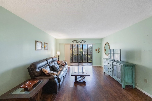 living room with dark hardwood / wood-style flooring and a textured ceiling