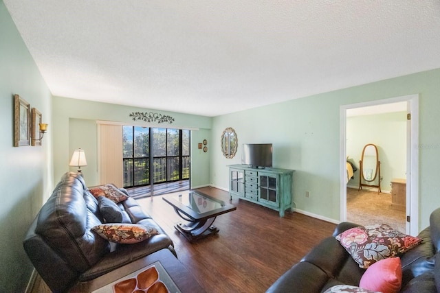 living room featuring a textured ceiling and dark wood-type flooring