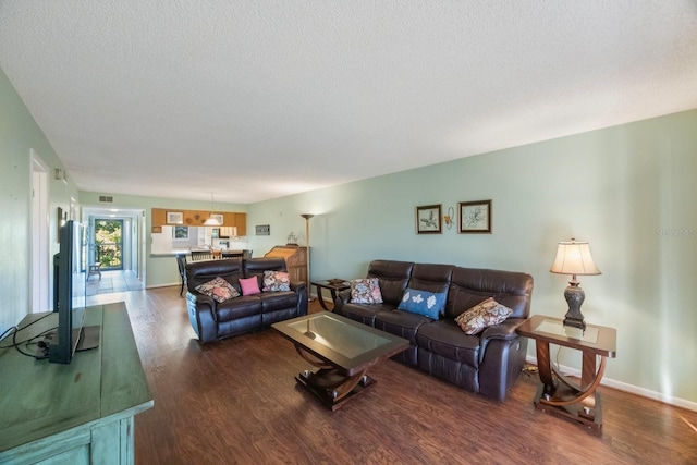 living room featuring a textured ceiling and hardwood / wood-style flooring