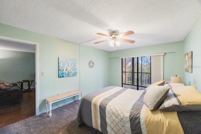 bedroom with dark colored carpet, a textured ceiling, access to outside, and ceiling fan