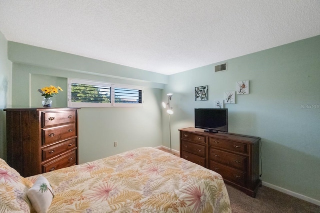 carpeted bedroom featuring a textured ceiling