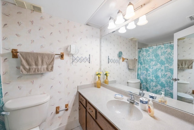 bathroom with vanity, toilet, and curtained shower