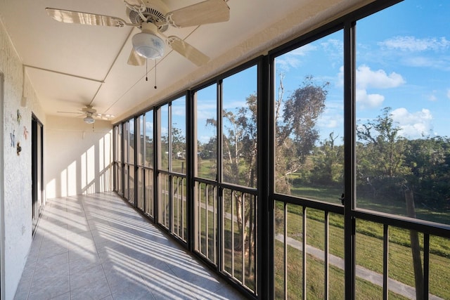 unfurnished sunroom featuring ceiling fan