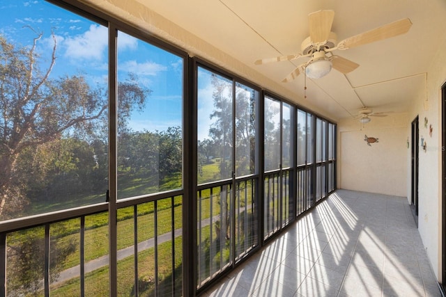 unfurnished sunroom with ceiling fan