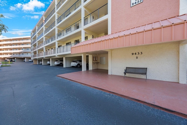 9433 Harbor Greens Way Unit 403, Seminole, FL 33776 - view of apartment building / complex featuring covered parking