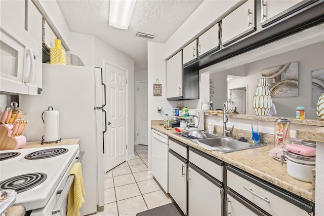 kitchen featuring a textured ceiling, white cabinetry, white appliances, and sink