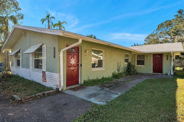 ranch-style house with a front lawn