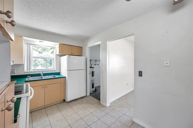 kitchen with electric water heater, white appliances, sink, and light tile patterned floors