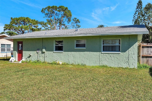 view of side of property with a lawn