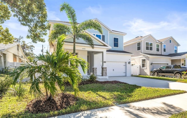 view of front of home featuring a garage and a front yard