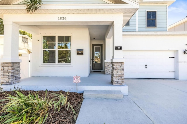 doorway to property featuring covered porch and a garage