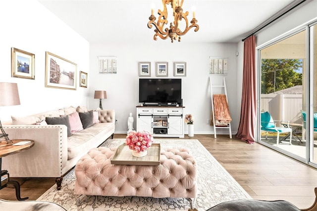 living room with a notable chandelier and hardwood / wood-style flooring