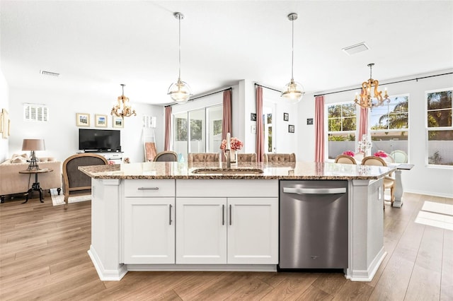 kitchen with white cabinetry, stainless steel dishwasher, a healthy amount of sunlight, and sink