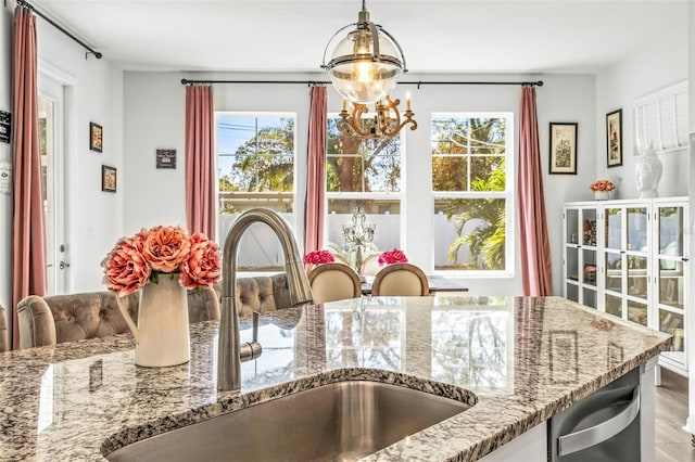 interior space with a chandelier, hardwood / wood-style flooring, a healthy amount of sunlight, and sink