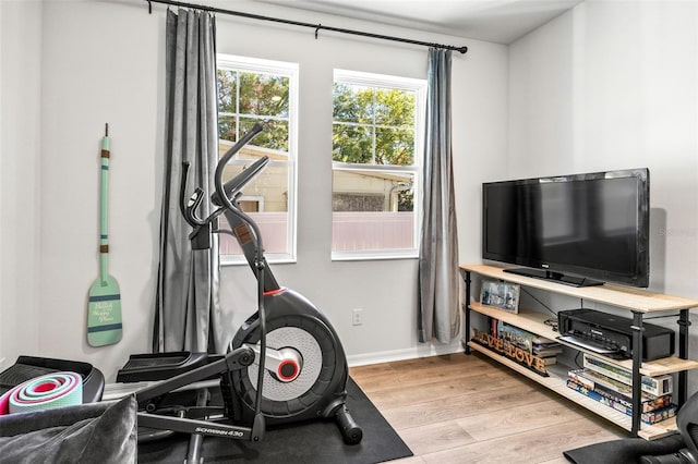 exercise room with light hardwood / wood-style flooring