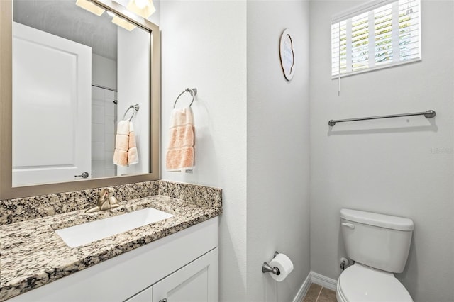 bathroom featuring tile patterned flooring, vanity, and toilet