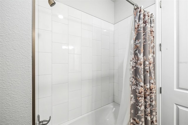 bathroom with shower / bath combo with shower curtain