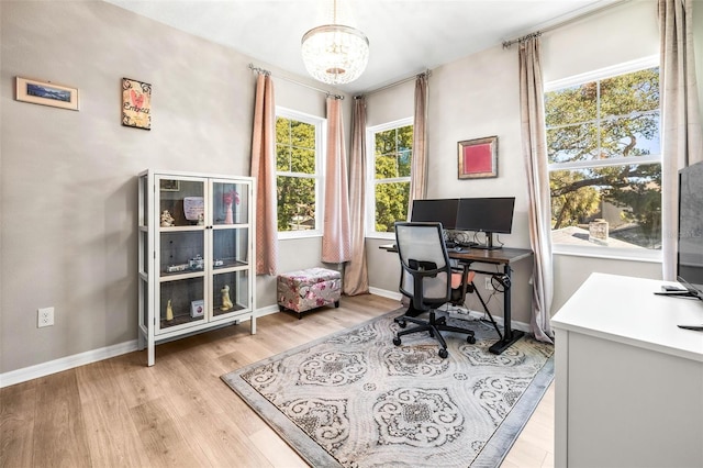 office featuring light wood-type flooring and an inviting chandelier