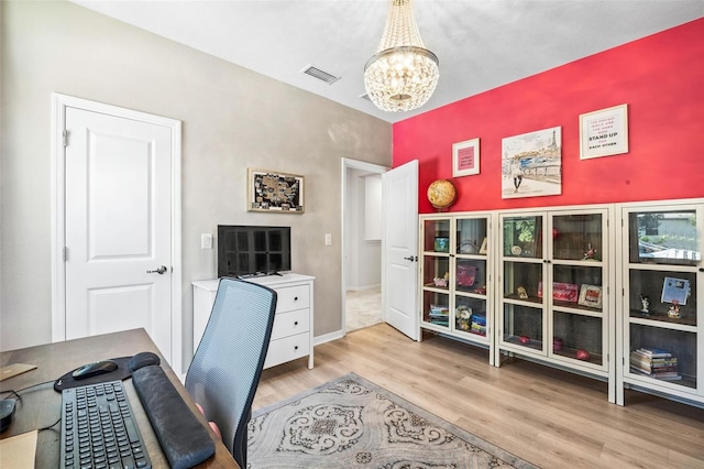 office area featuring light hardwood / wood-style floors and an inviting chandelier