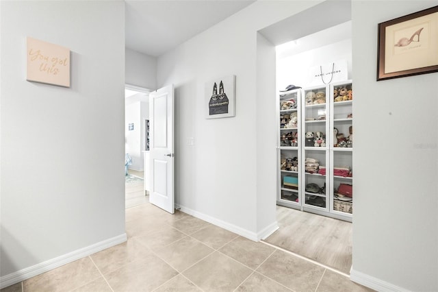 corridor featuring light tile patterned flooring