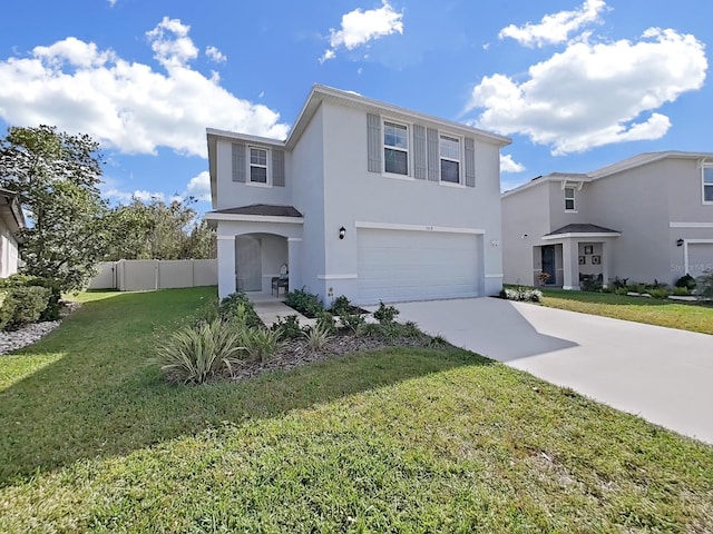 view of property featuring a front yard and a garage