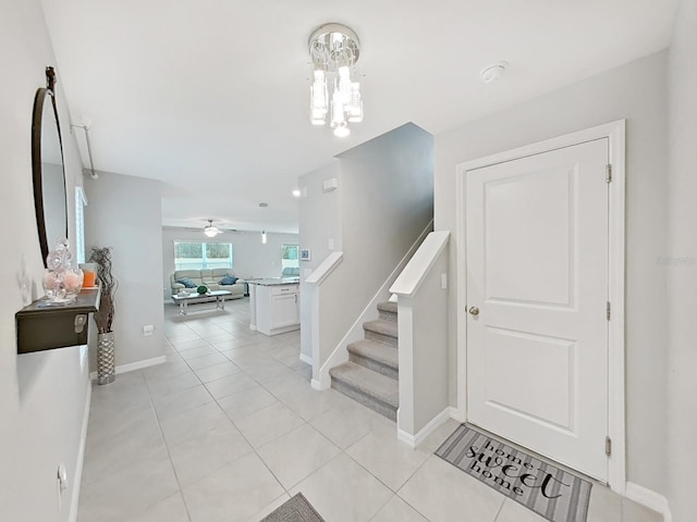 foyer featuring ceiling fan and light tile patterned floors