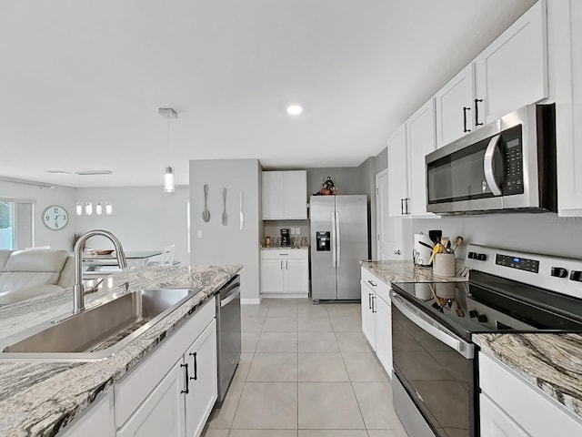 kitchen featuring pendant lighting, white cabinetry, sink, and appliances with stainless steel finishes