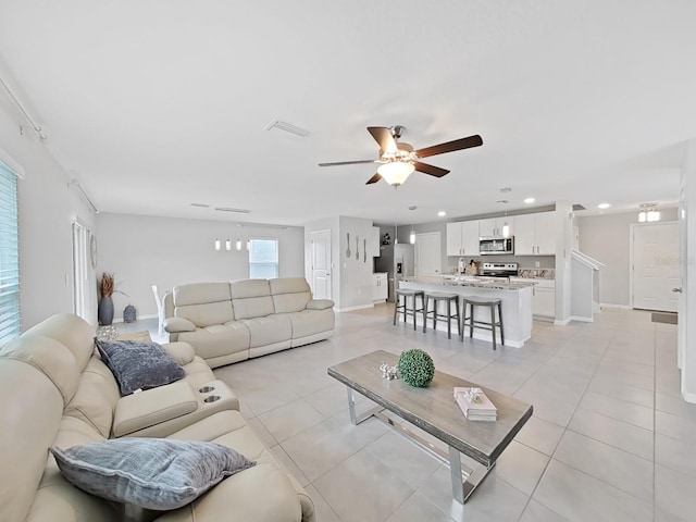 living room with ceiling fan and light tile patterned floors