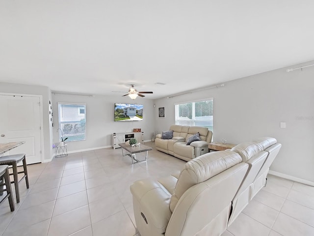 tiled living room with ceiling fan