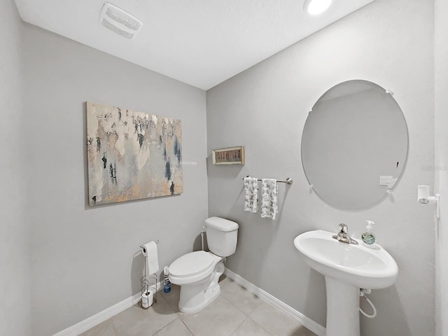 bathroom with sink, tile patterned flooring, and toilet