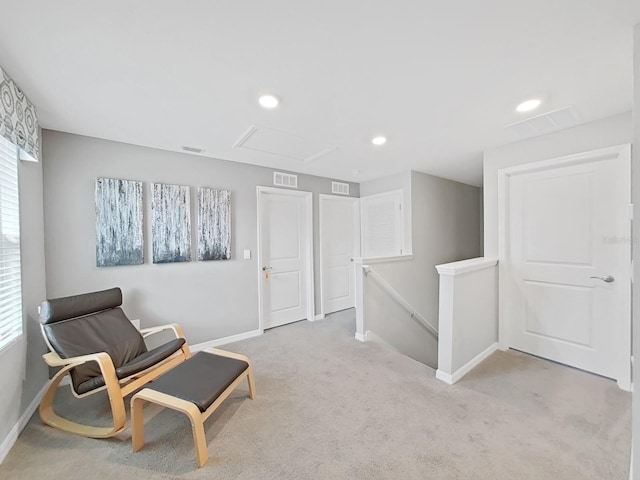 living area featuring light colored carpet