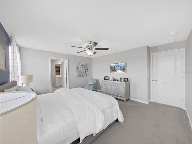 carpeted bedroom with ceiling fan and ensuite bathroom