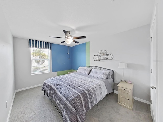 bedroom featuring light carpet and ceiling fan