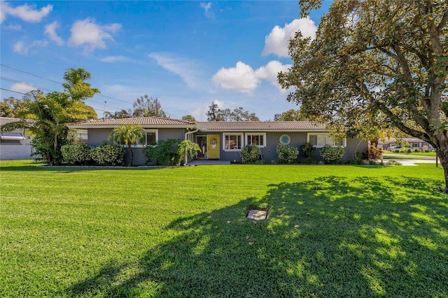 ranch-style home with a front lawn