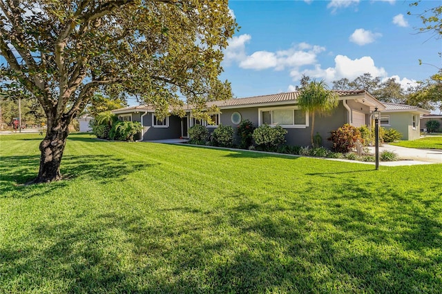 view of front of property with a garage and a front lawn