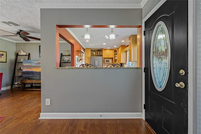 entryway featuring crown molding, ceiling fan, a textured ceiling, and hardwood / wood-style flooring