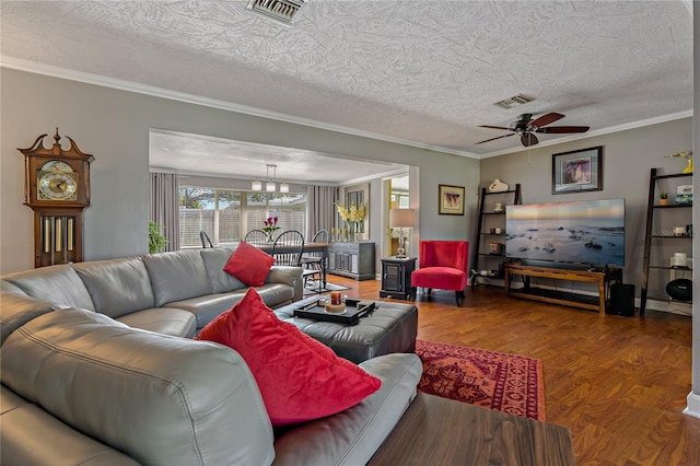 living room featuring a textured ceiling, ceiling fan with notable chandelier, wood-type flooring, and ornamental molding