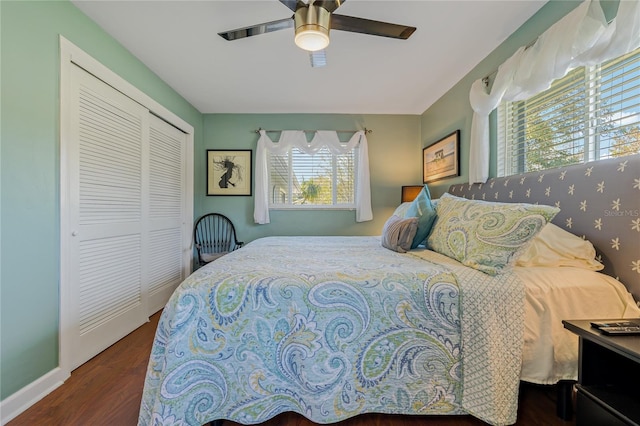 bedroom featuring ceiling fan, dark hardwood / wood-style flooring, and a closet