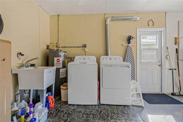 laundry area with separate washer and dryer, water heater, and sink