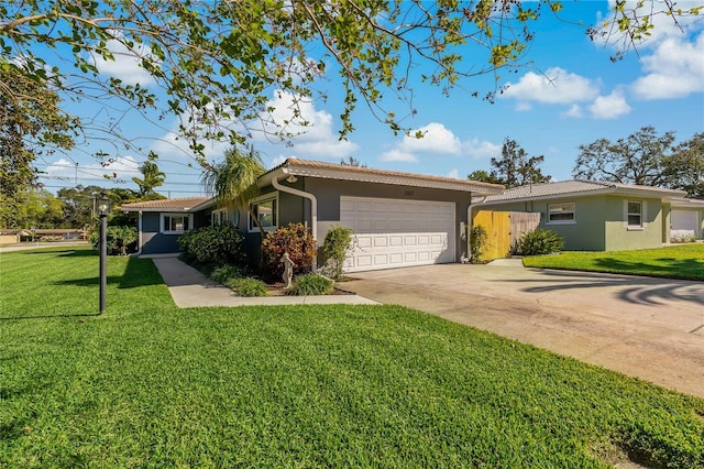 ranch-style house featuring a front yard and a garage