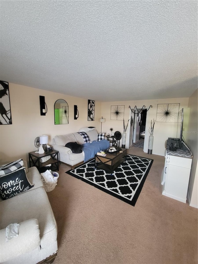 carpeted living room featuring a textured ceiling