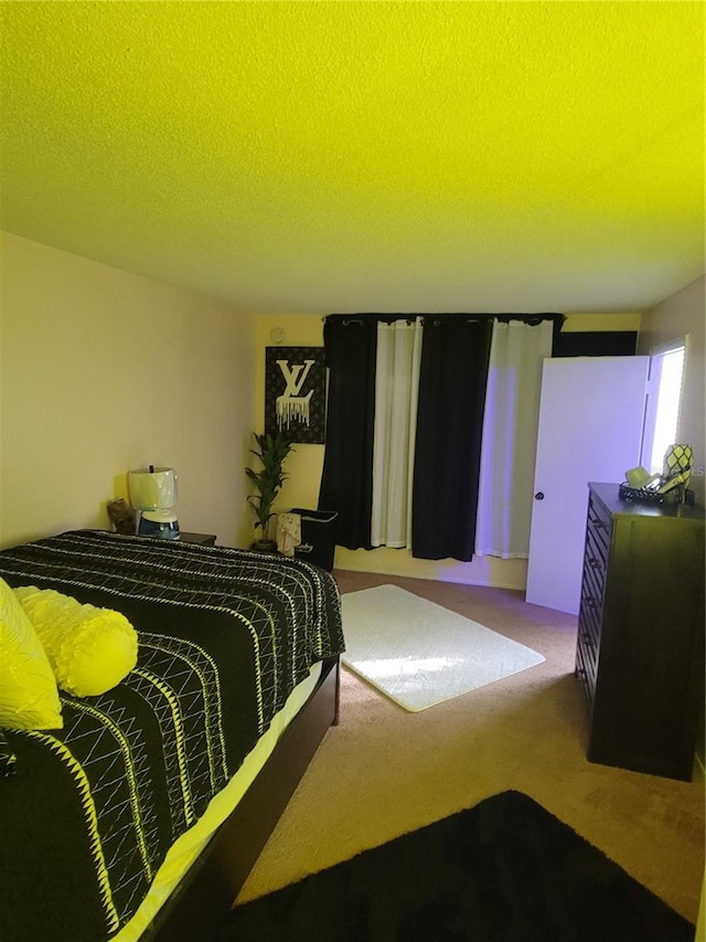 bedroom featuring carpet and a textured ceiling