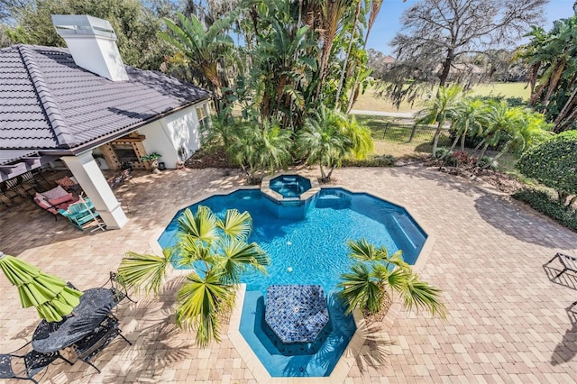 view of swimming pool with a patio area and an in ground hot tub