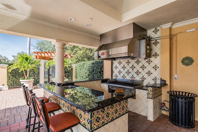 view of patio with an outdoor bar, grilling area, and exterior kitchen