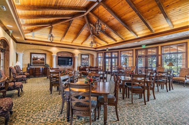 dining space featuring french doors, carpet, beamed ceiling, and an inviting chandelier