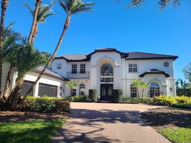 mediterranean / spanish home featuring a garage