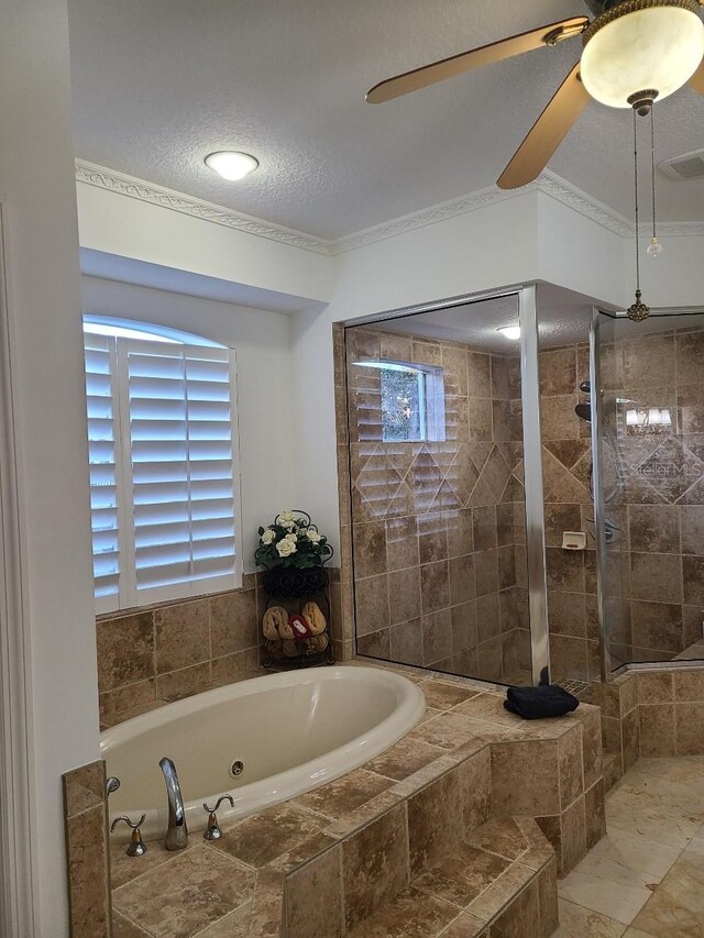 bathroom with a relaxing tiled tub, crown molding, and a textured ceiling