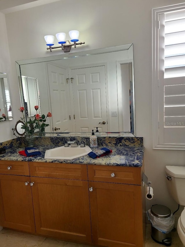 bathroom with tile patterned floors, vanity, and toilet